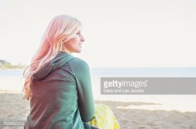 Caucasian woman sitting on beach